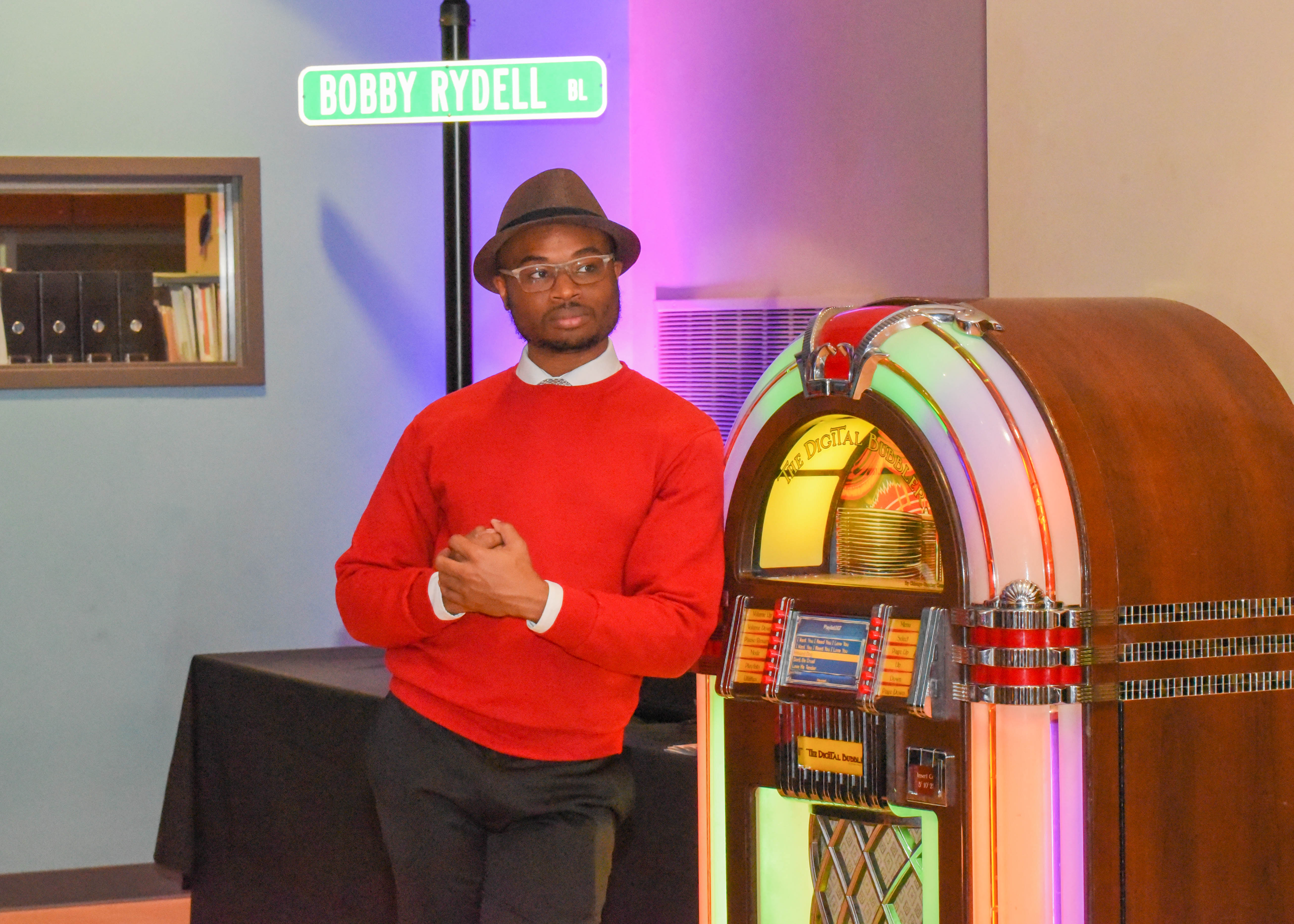 man leaning against jukebox