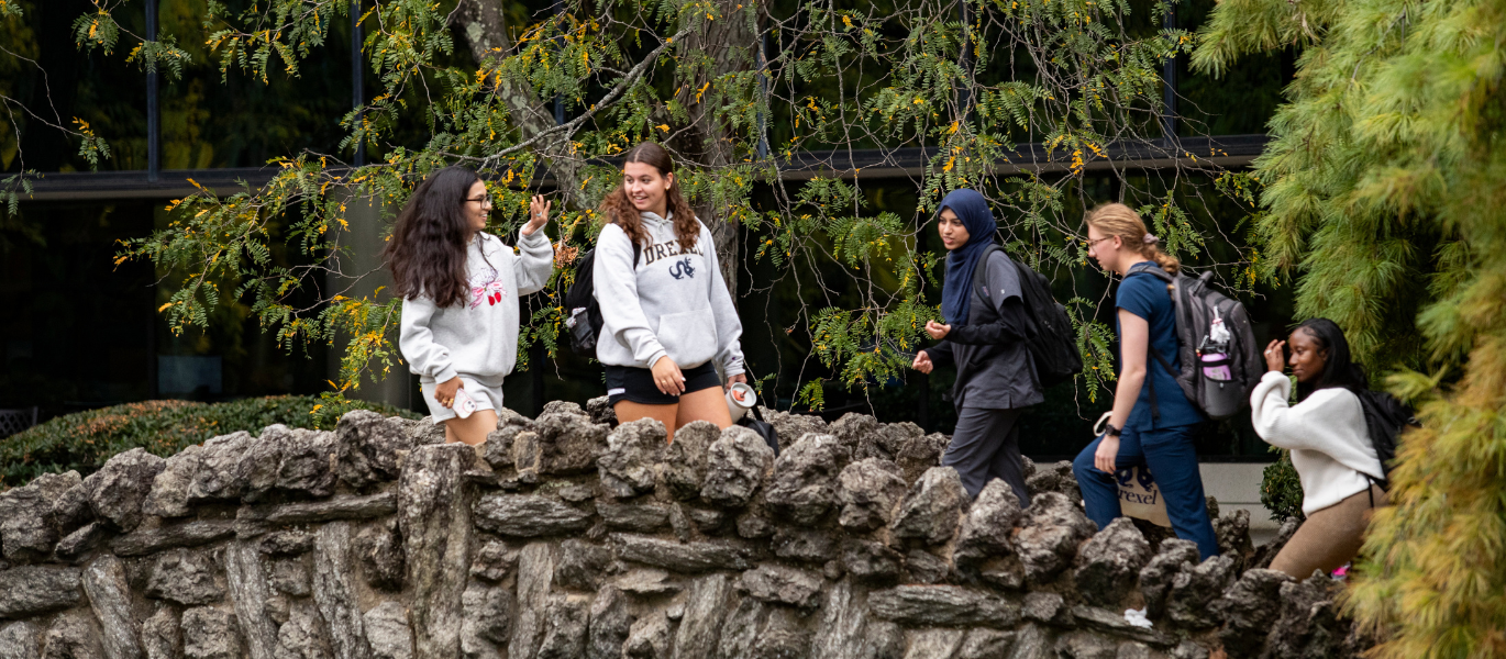 students walking on the campus bridge