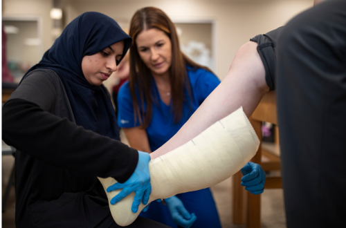 student and faculty with patient