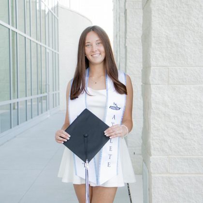 Lilly holding her grad cap