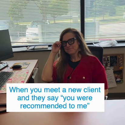 counseling taking off her glasses while sitting at desk
