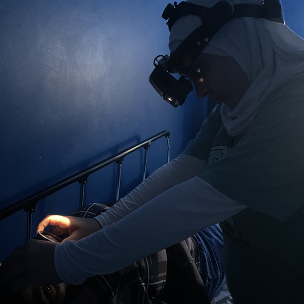 optometry student with lens