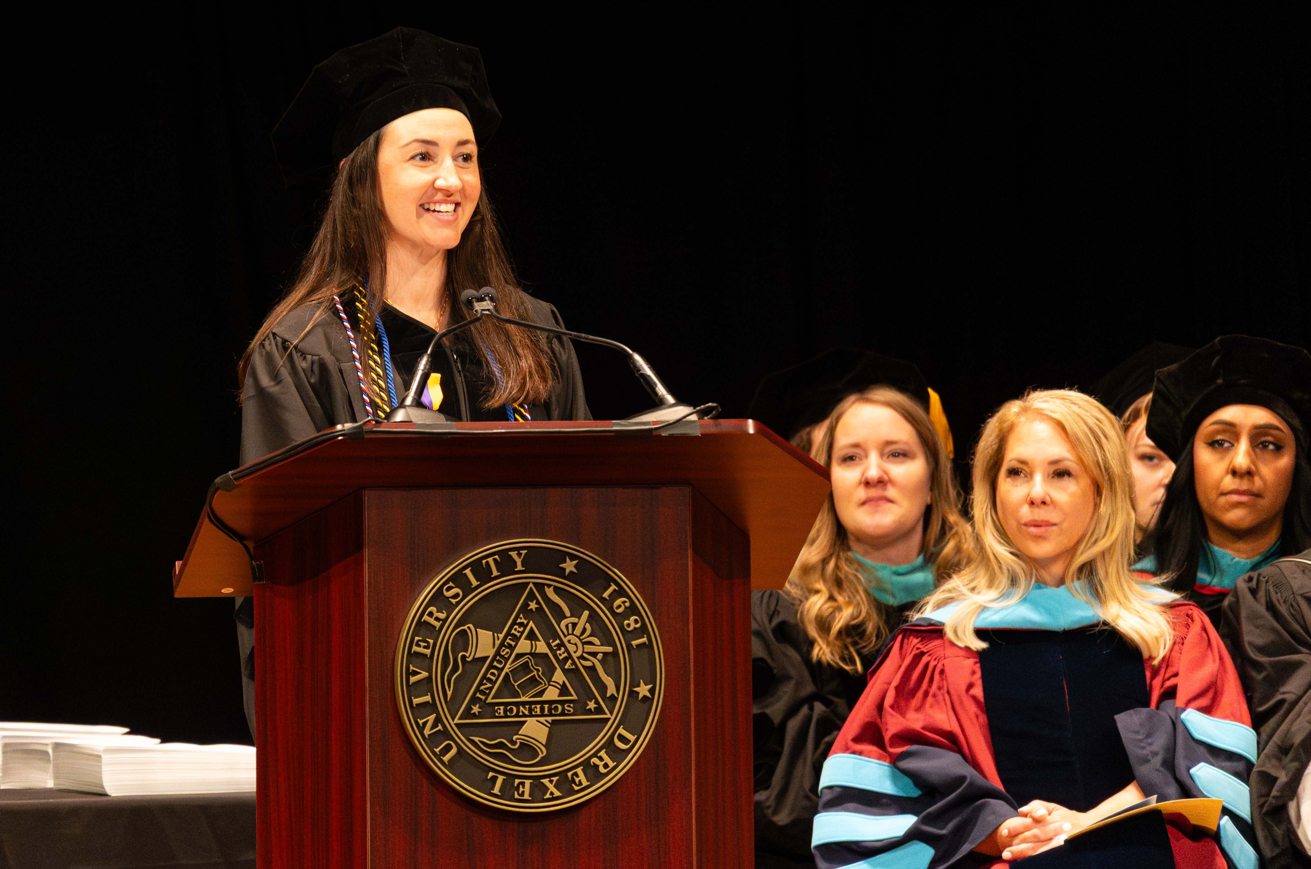 PCO valedictorian Anna German at the podium