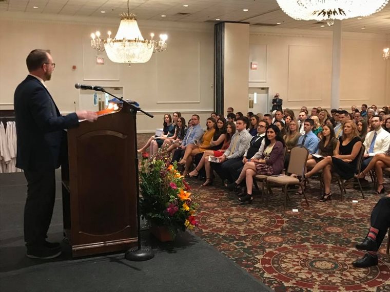 Speaker on stage at White Coat Ceremony