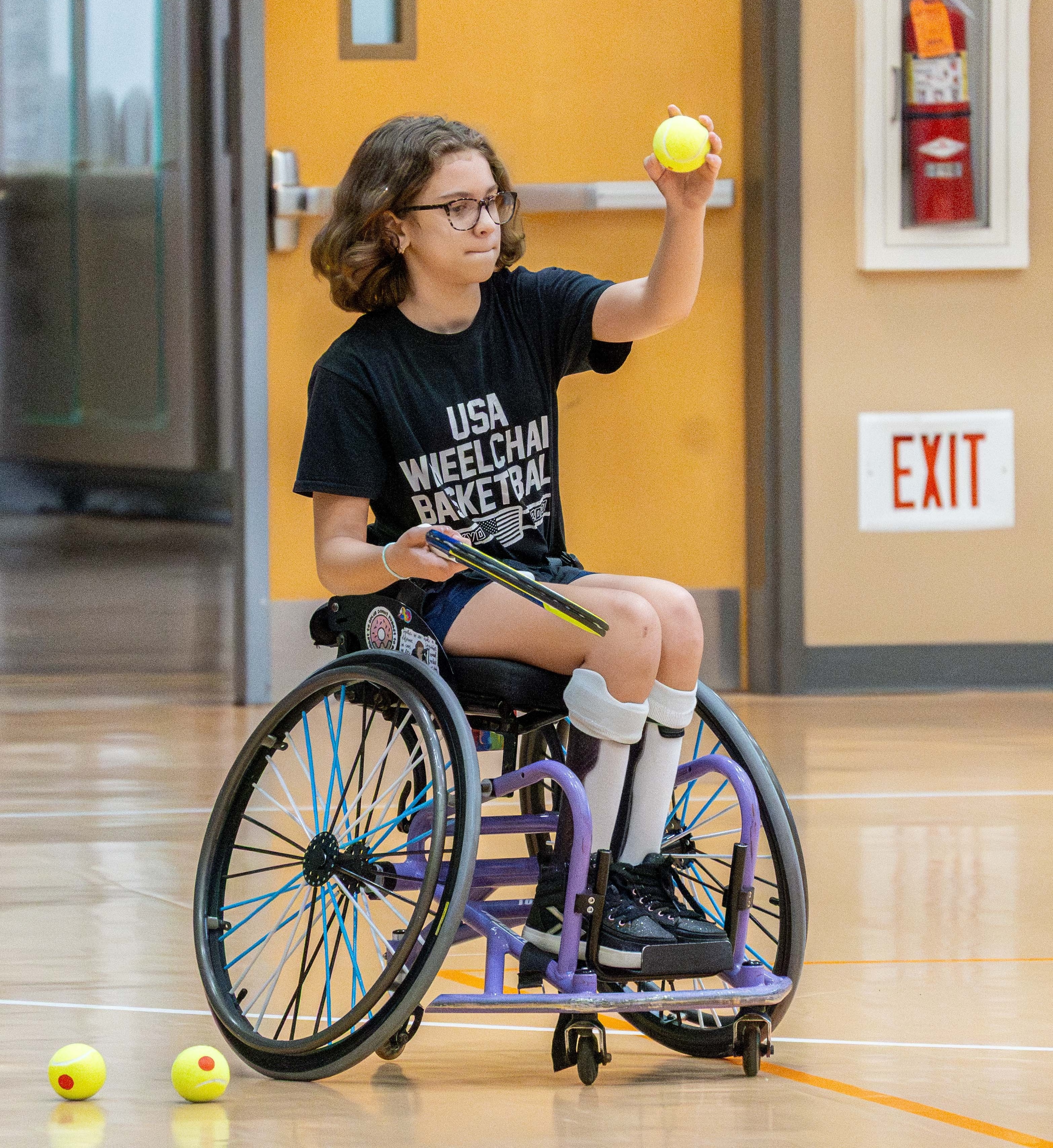 Ivy Glaser, 11, participating in wheelchair tennis