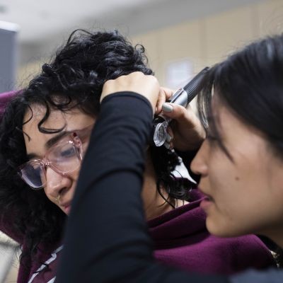 Student does ear exam on patient in lab thumbpic1