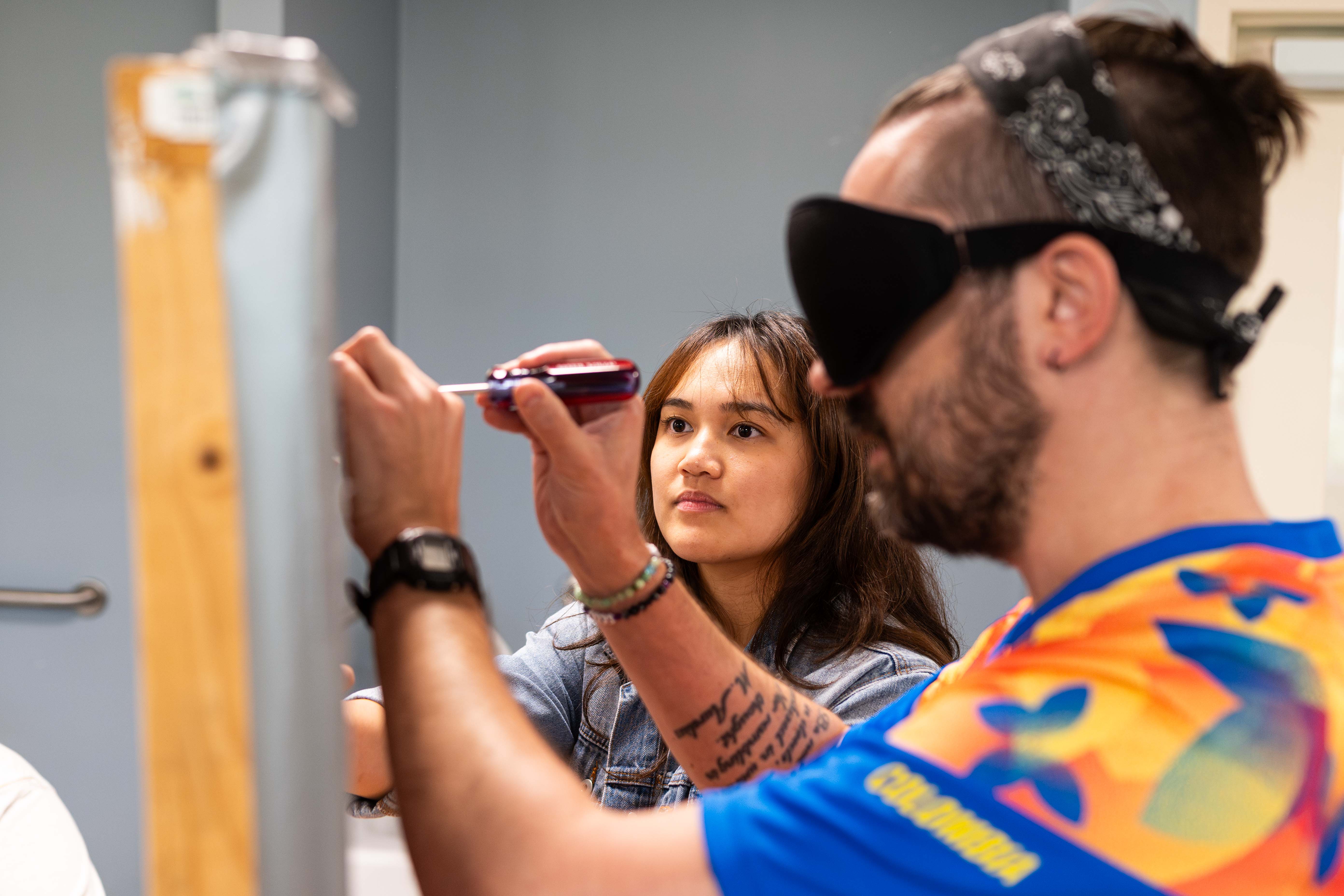 VRT student using a screwdriver while blindfolded