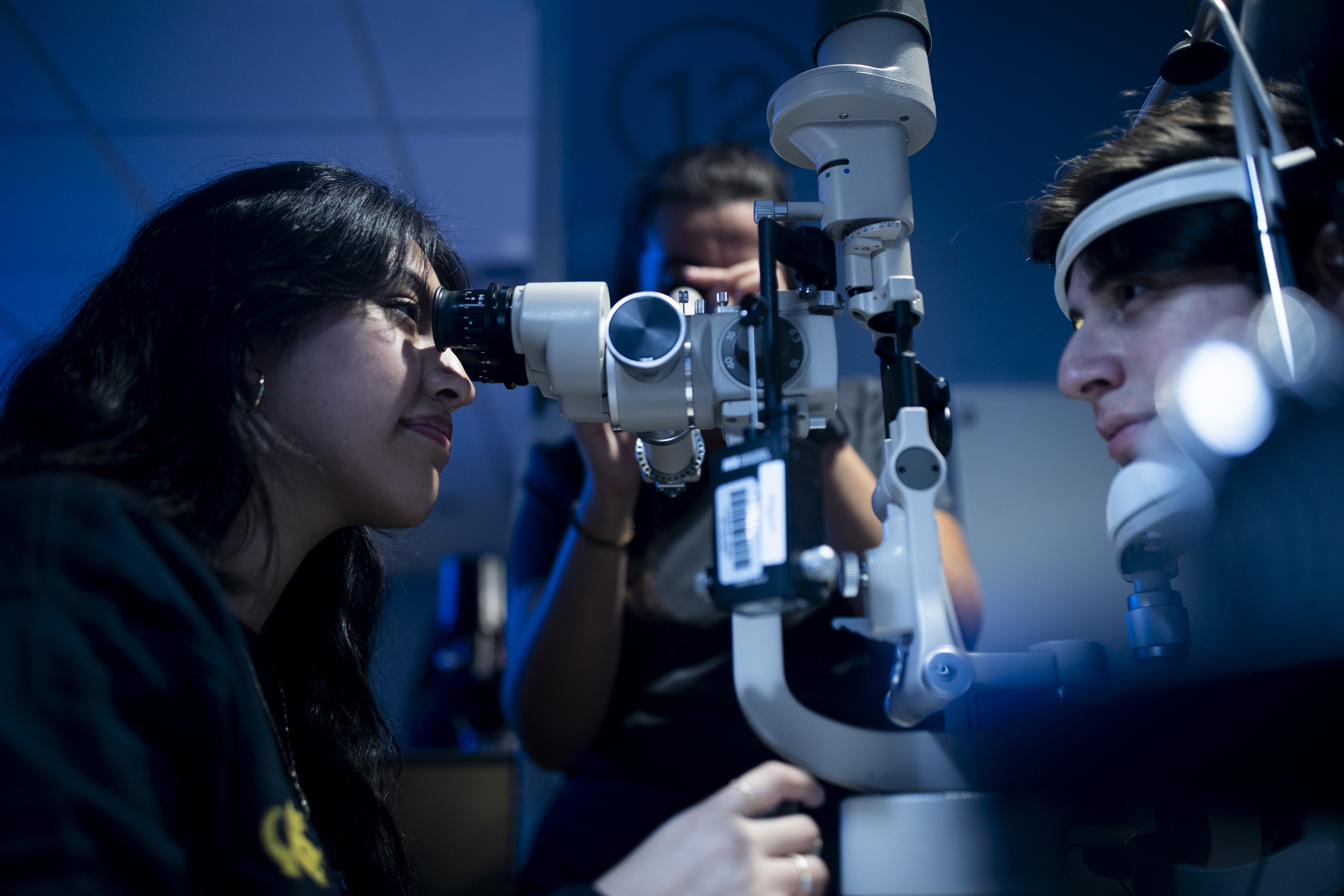 Patient being examined by student in the eye lab