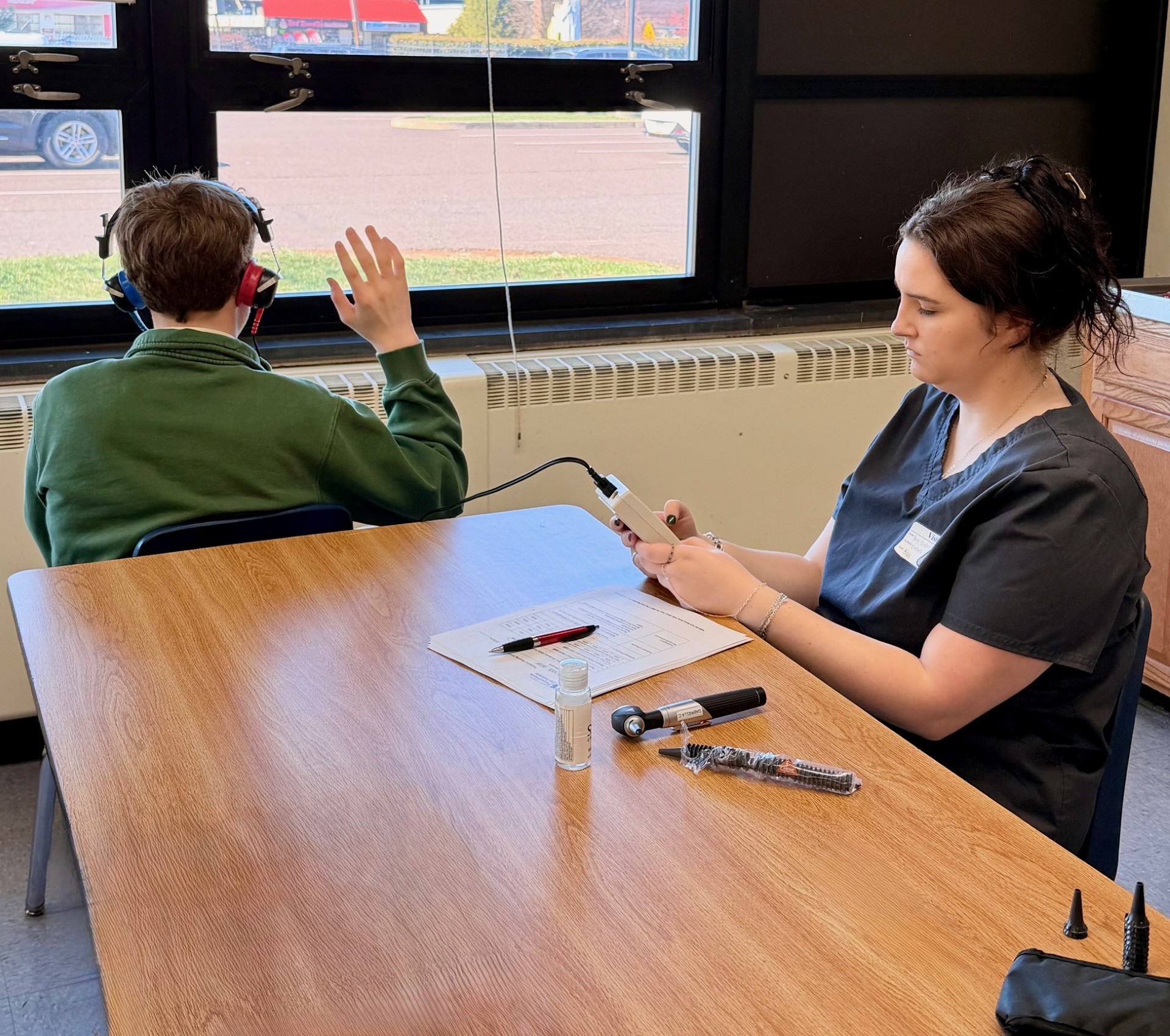 PEI students conducts hearing test on child
