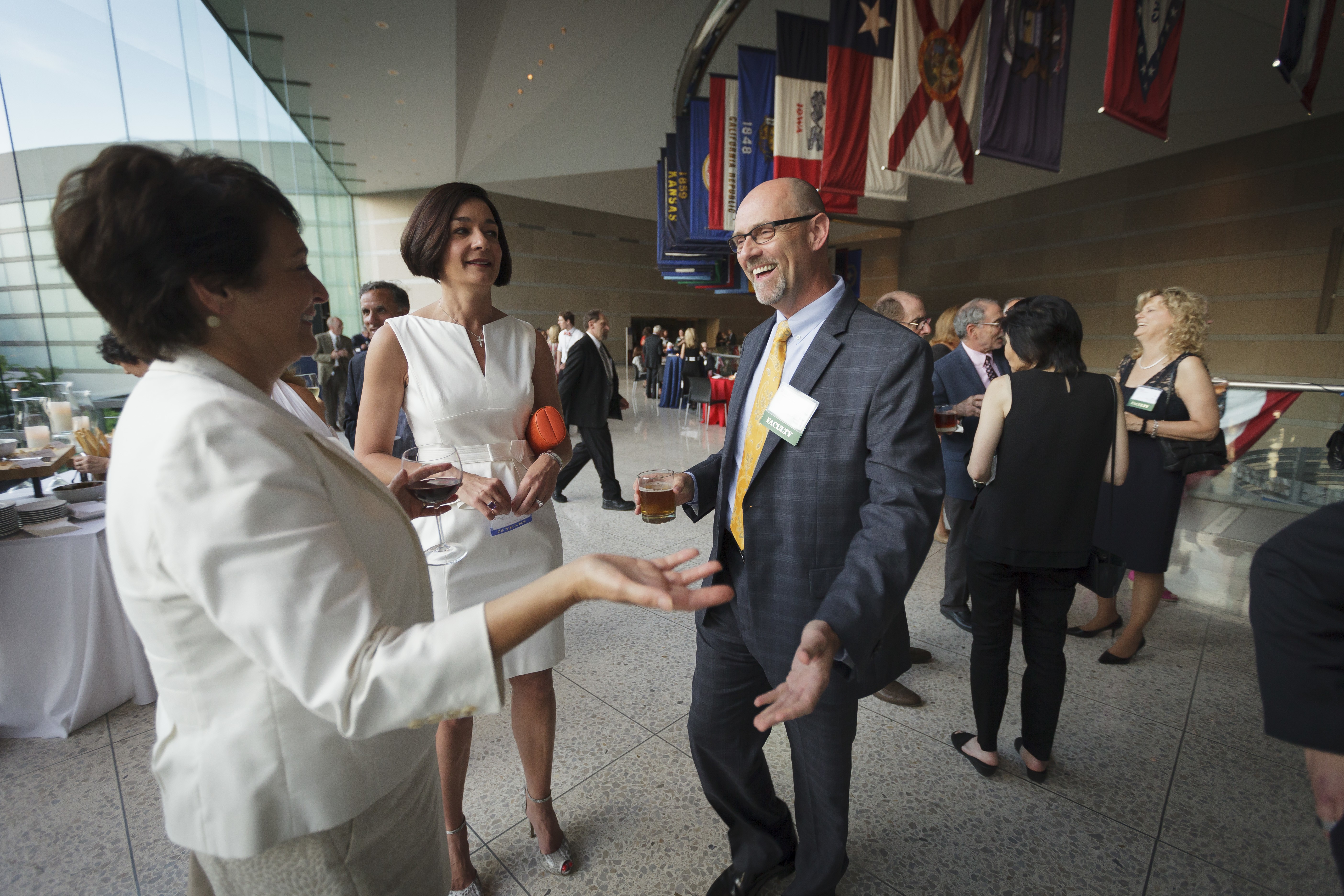 Two alumni greet each other at event