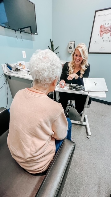 Emily McMahan treating tinnitus patient in clinic