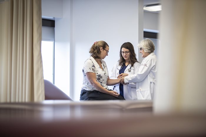 Patient and doctors during an exam