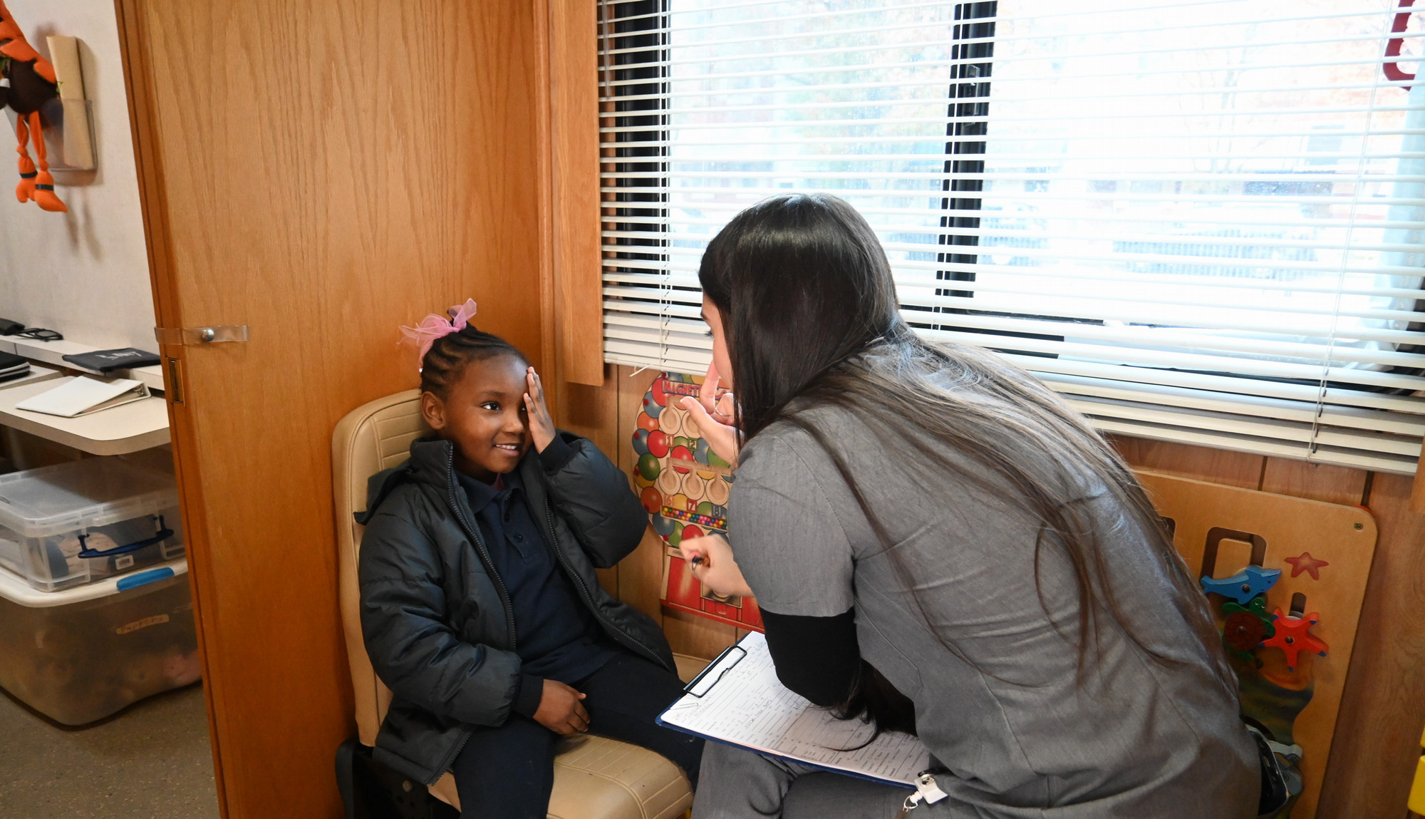 Young student takes eye test on the bus