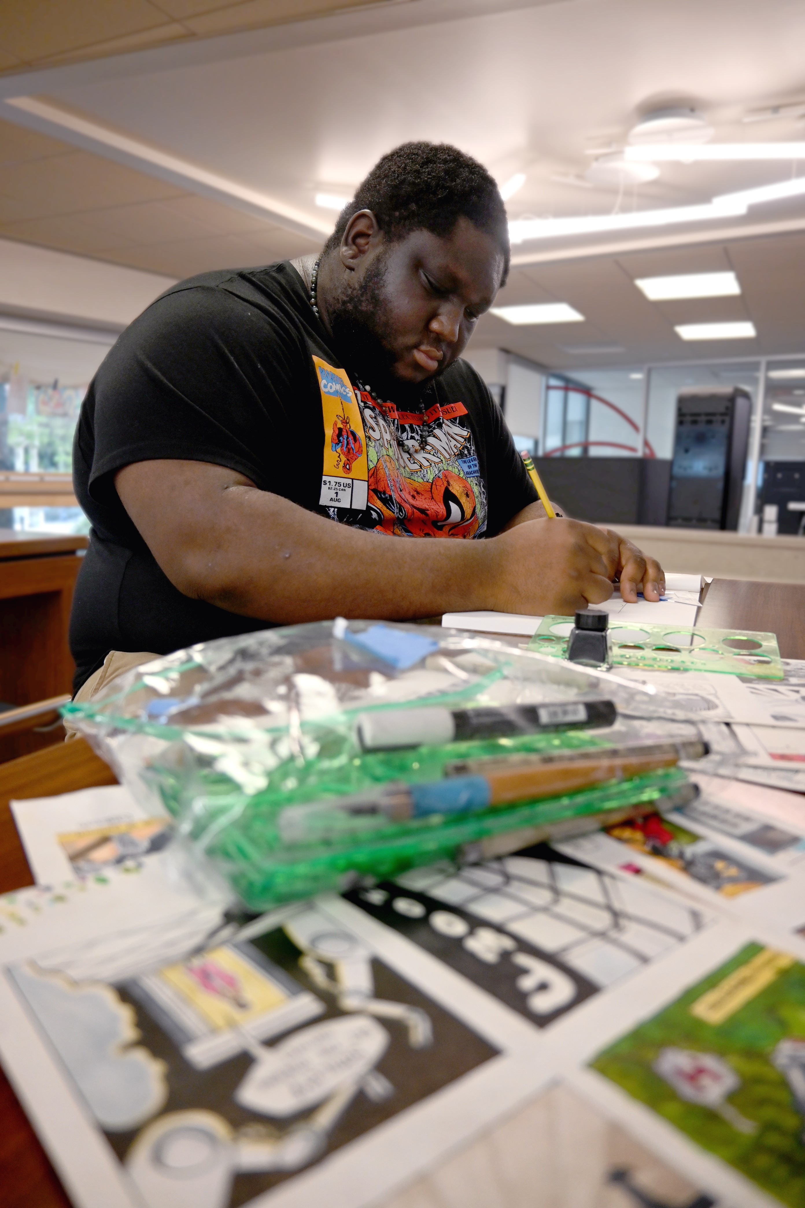 Kevin Aninta drawing comics in the library pic1