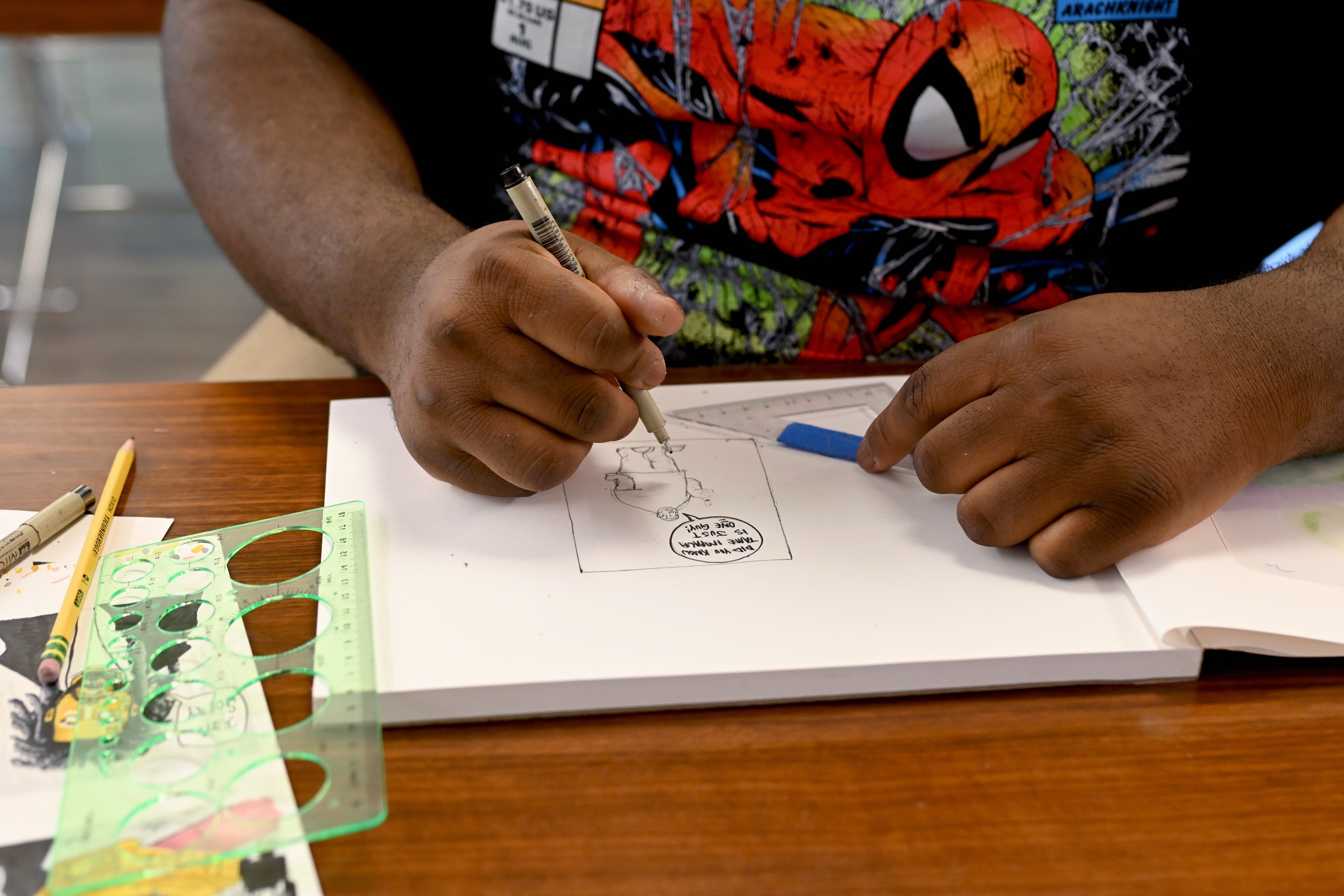 Close up of Kevin Aninta's hands drawing