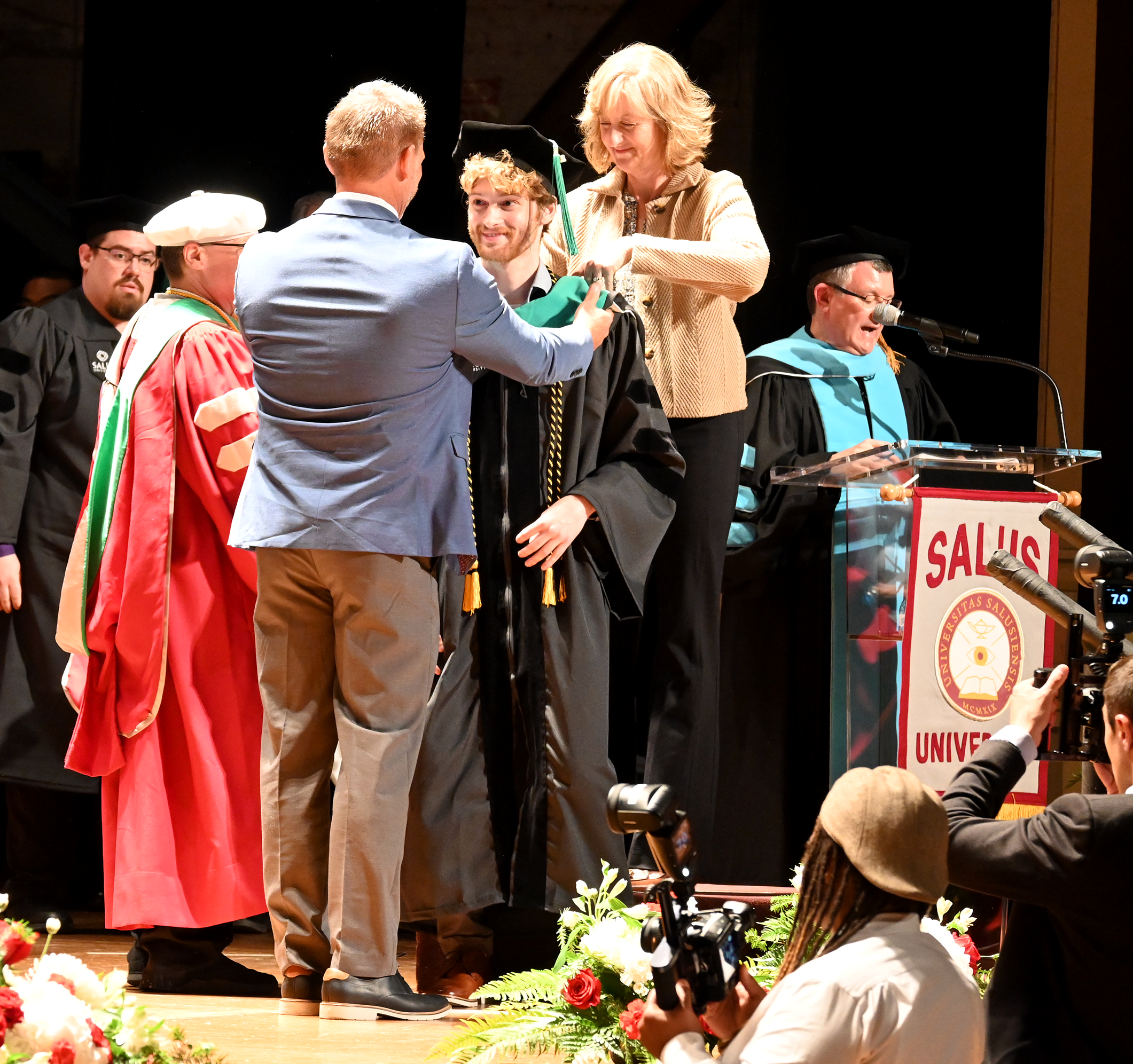 Alex Kirns getting hooded by his parents