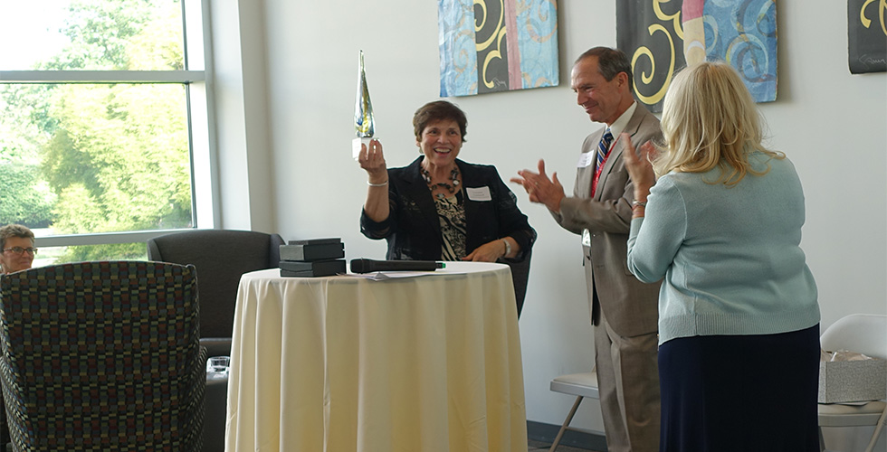 Dr. Lombardi holding an award