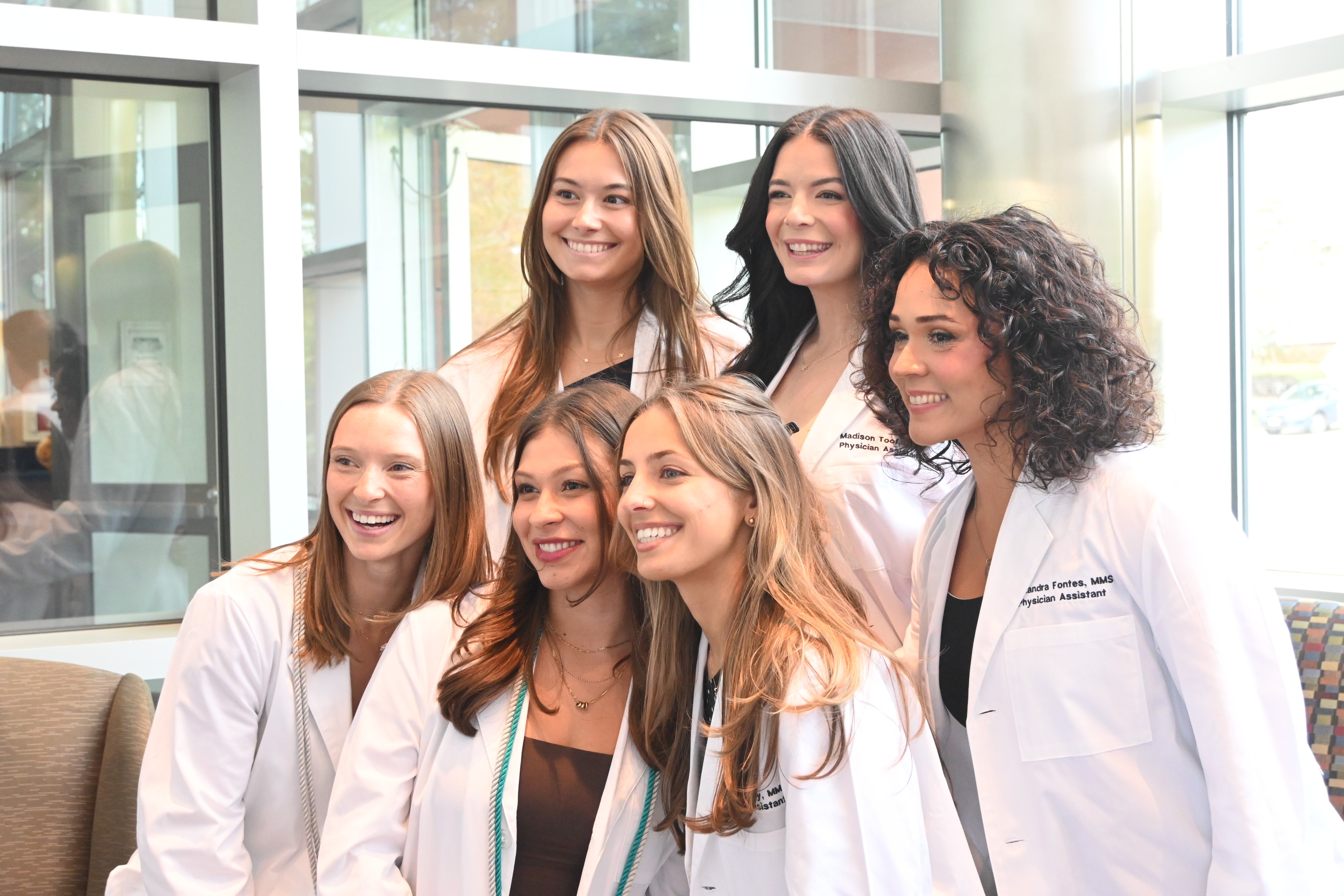 Small group of PA students in long white coat pic1