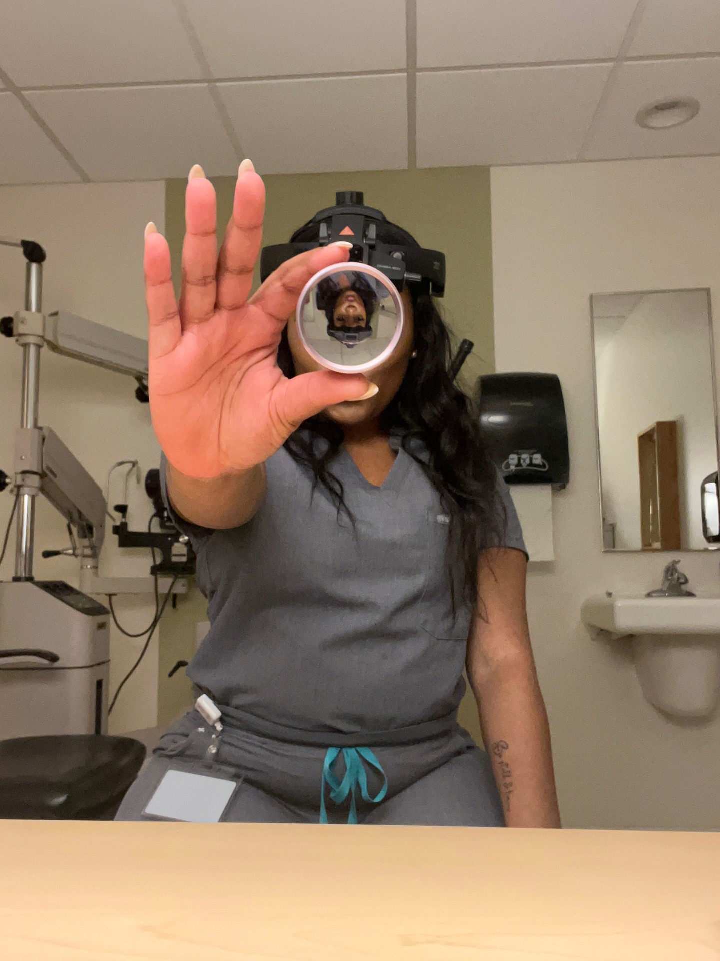 Dr. Williams holding a lens to her face