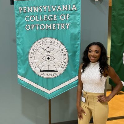Dr. Williams standing in front of the PCO flag thumbpic