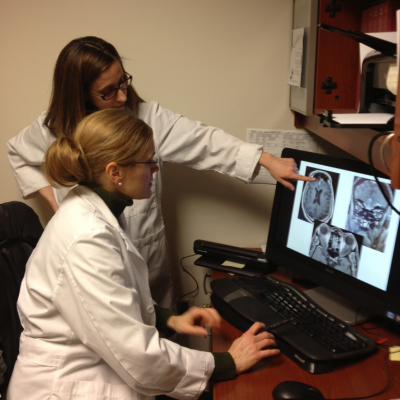 two optometrists looking at neuro images on computer