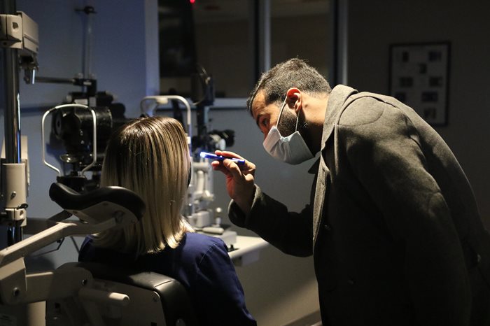 Student performing an eye exam