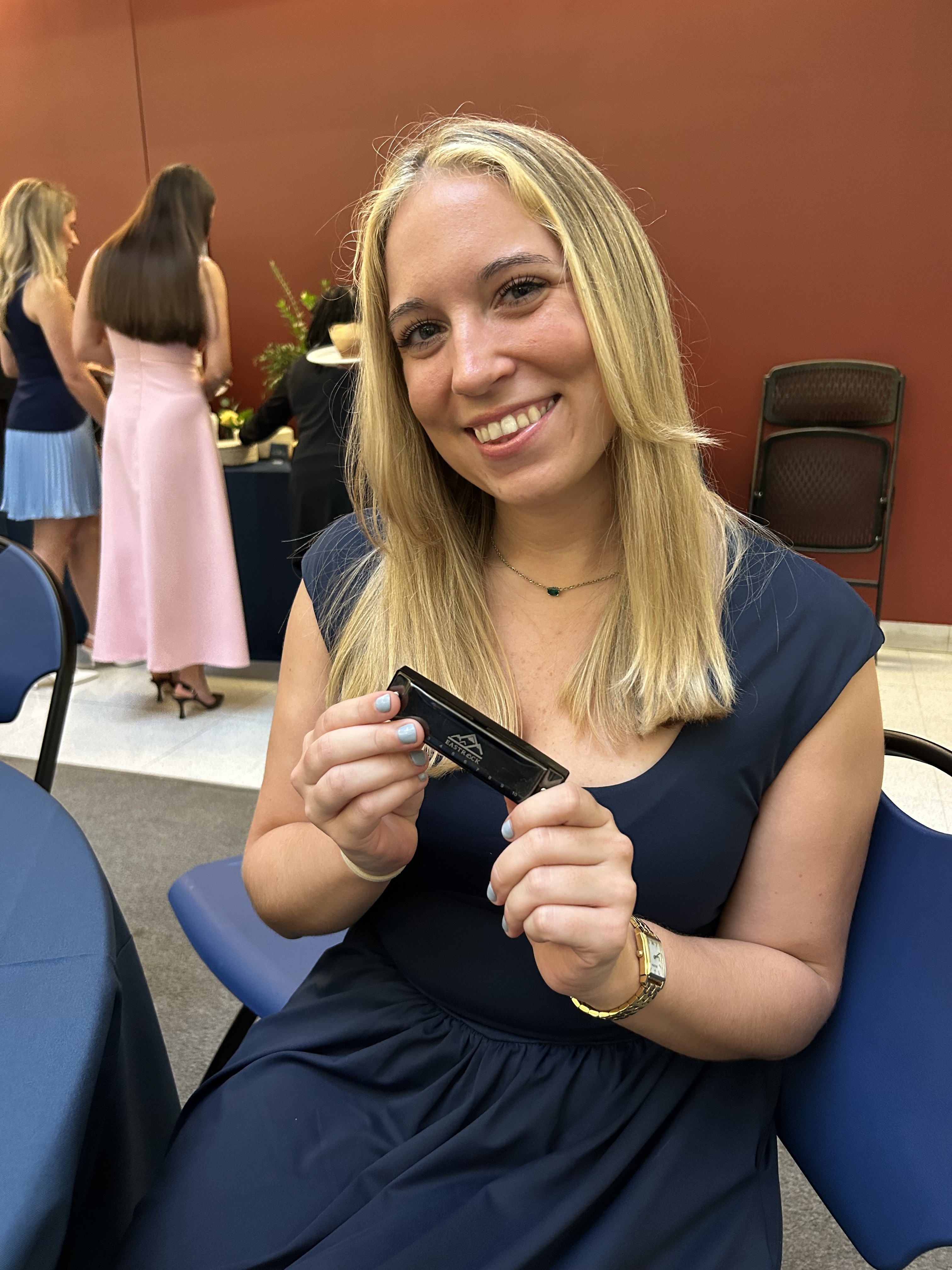 Amanda Dearborn and her harmonica before white coat
