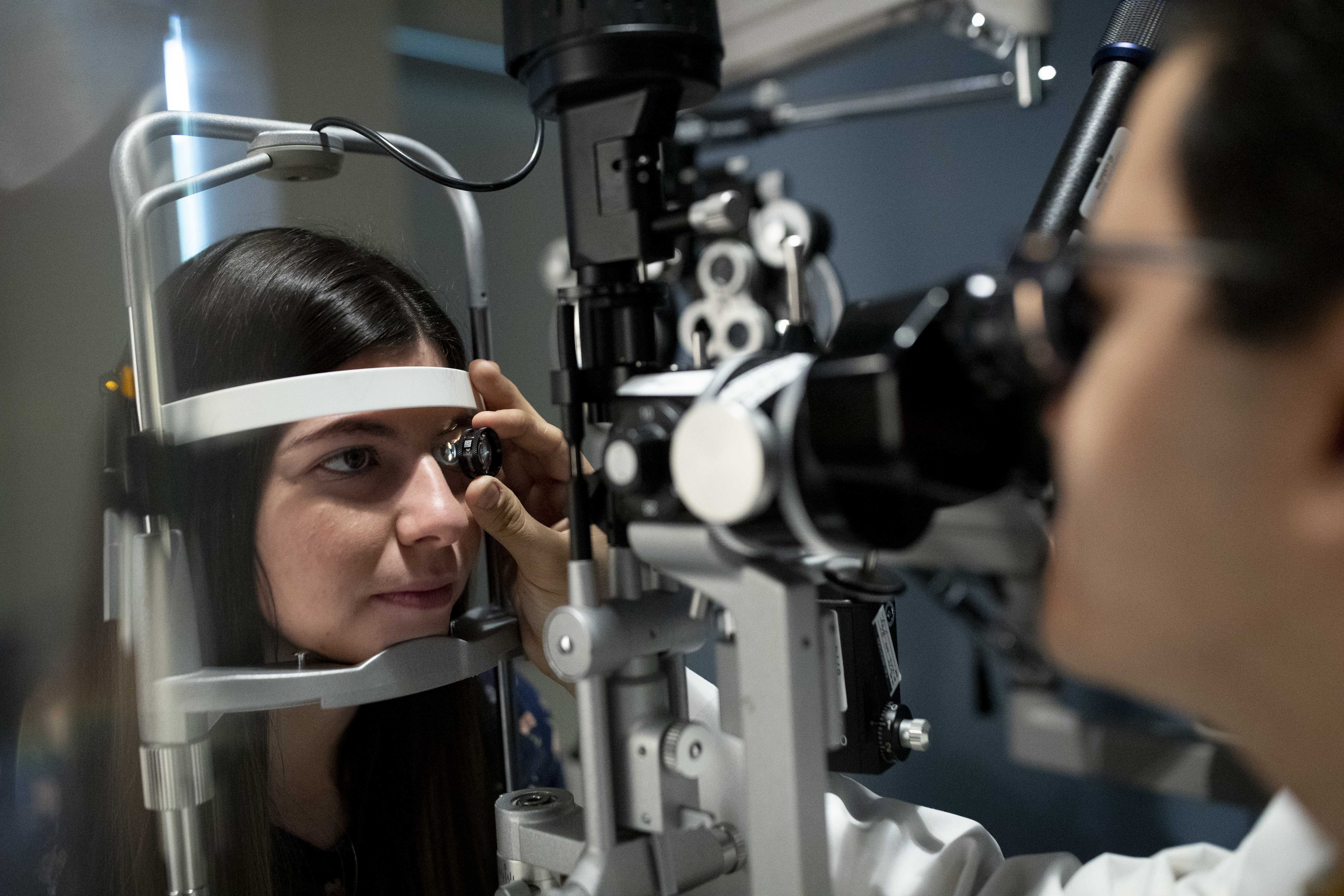 Student examines patient in OD lab pic1