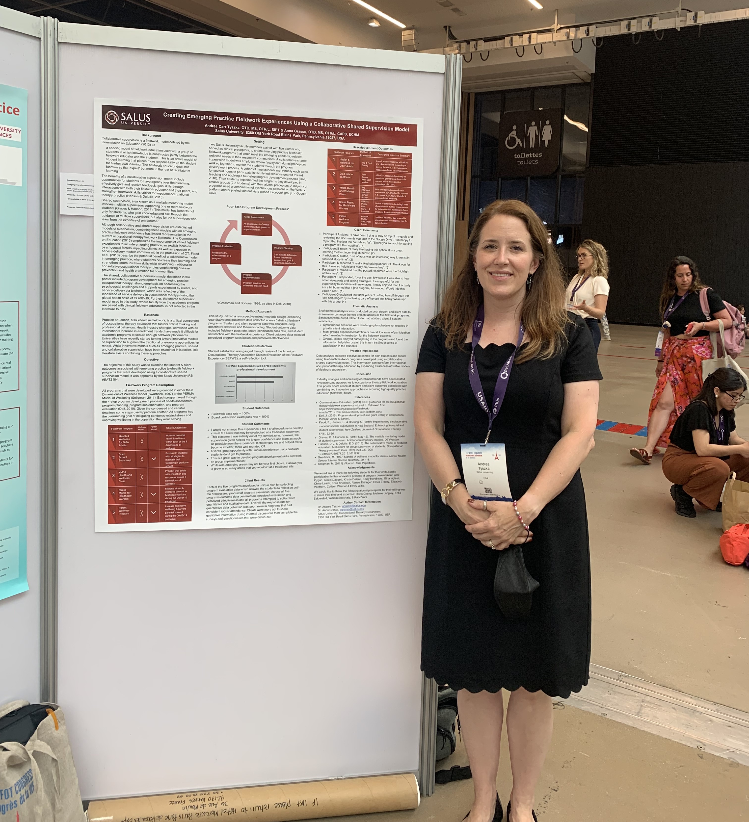 Andrea Tsyzka in front of poster presentation