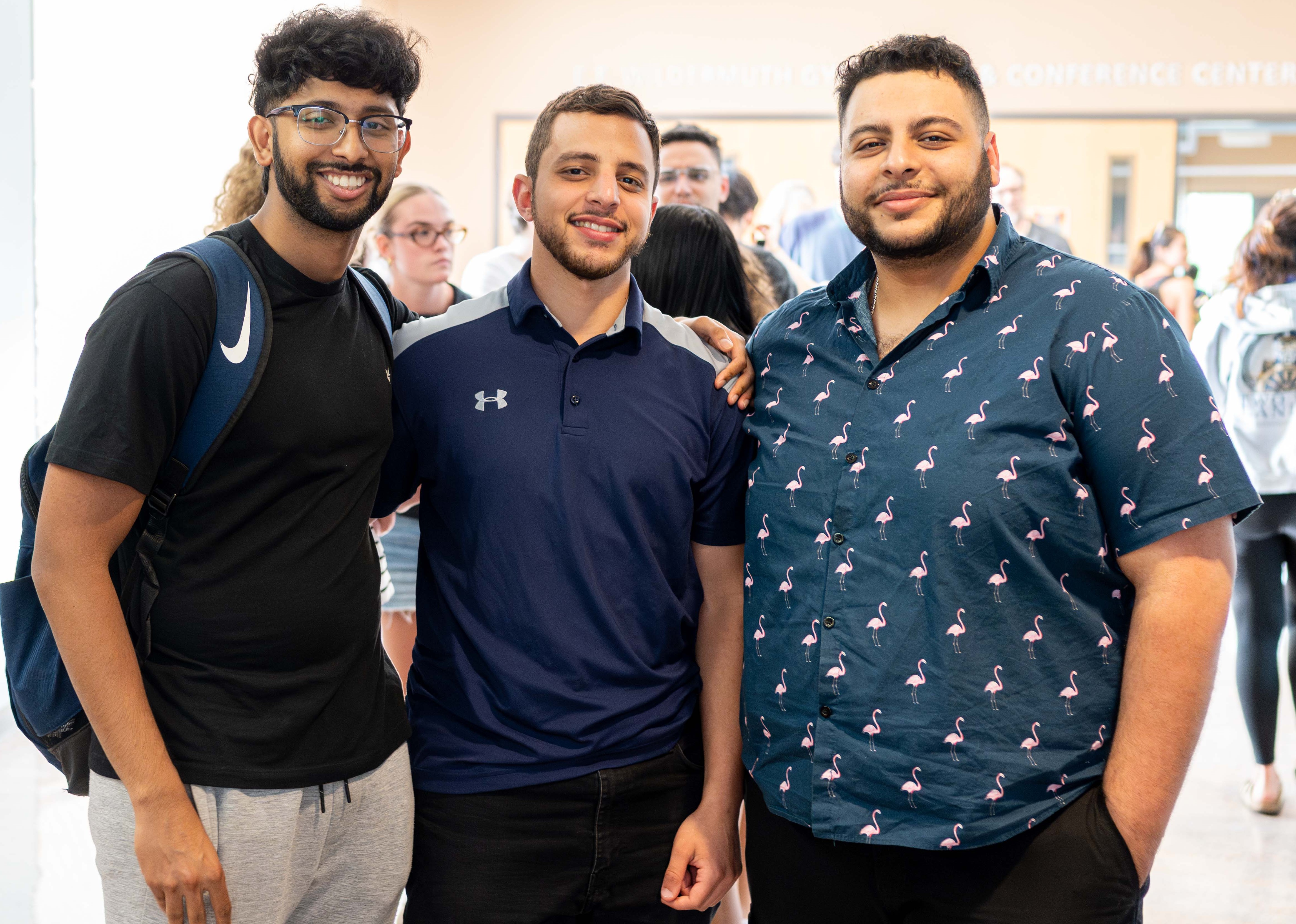 Three OD students in line for food at summer barbecue