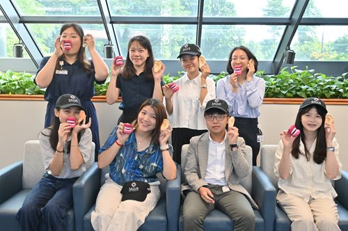 DICE cohort from Taiwan posing with mouth and ear stress toys