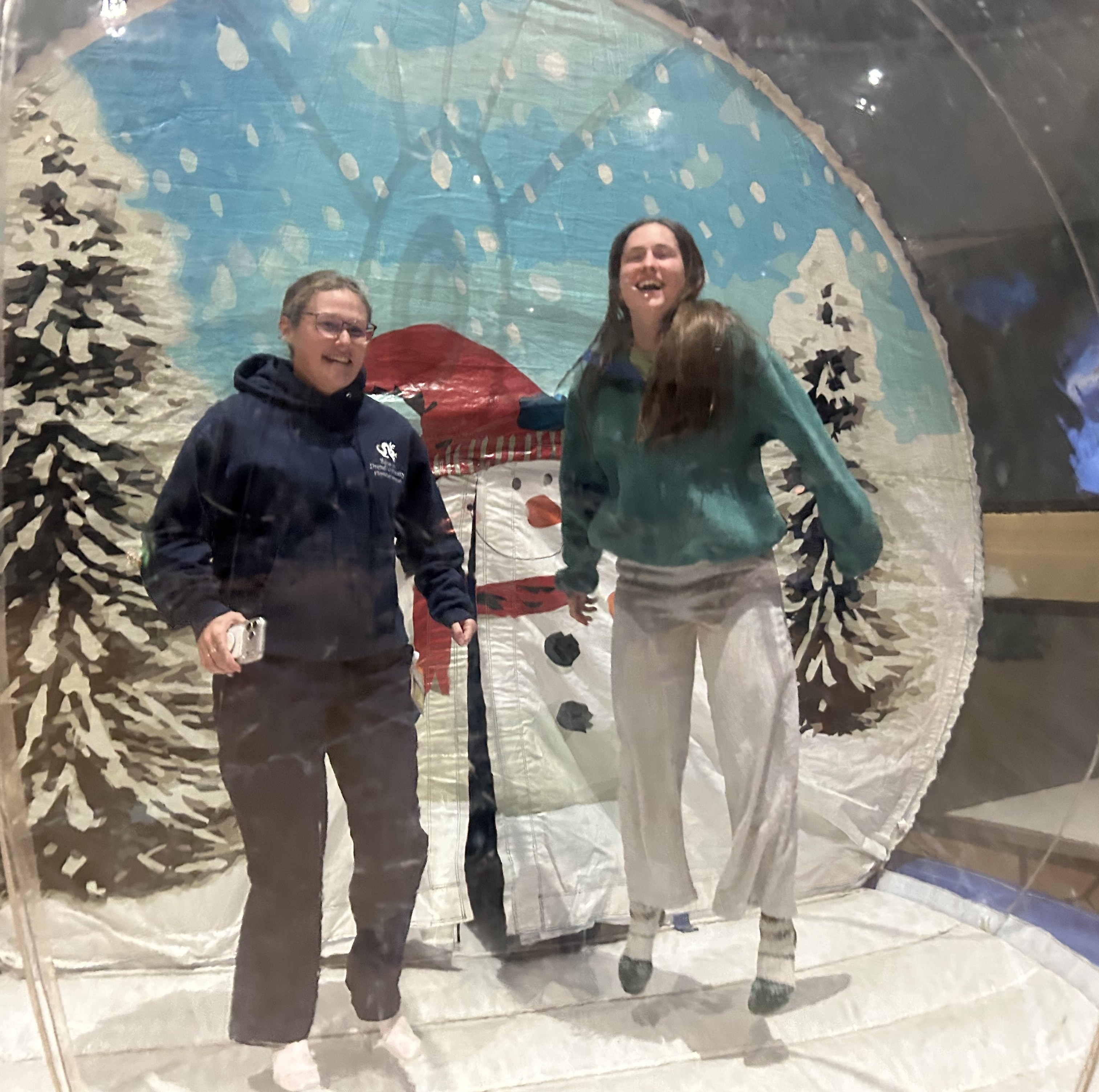 Two students bouncy bouncy in giant snow globe pic1