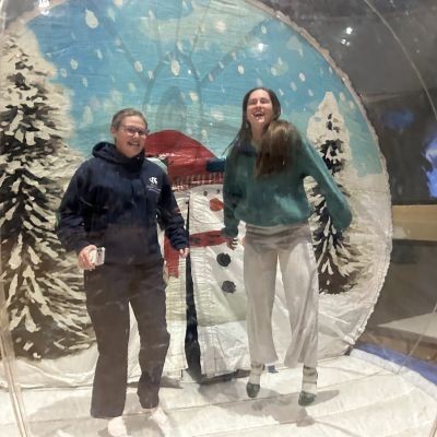 Two students bouncy bouncy in giant snow globe at Winterfest thumbpic1