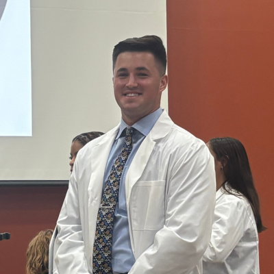 Aleks wearing his white coat
