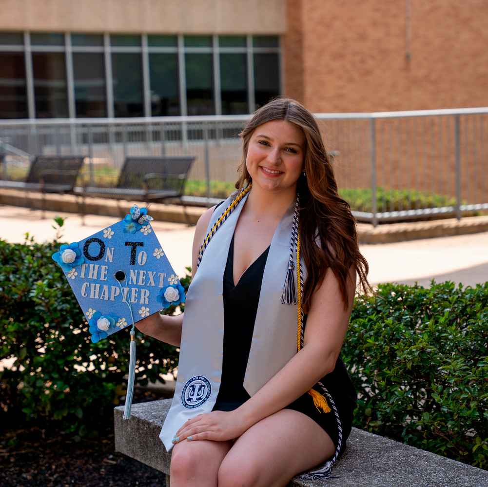 Ashley holding her grad cap