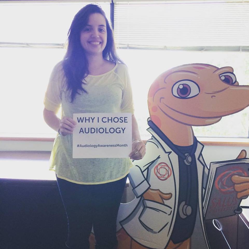 Elisa standing with a cardboard cutout Sal