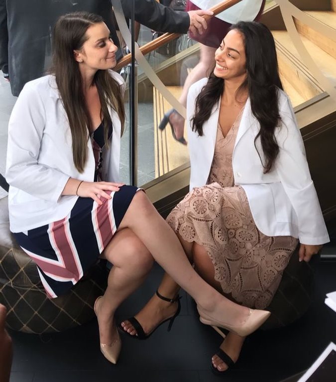 Emma Gohmann and friend in their white coats