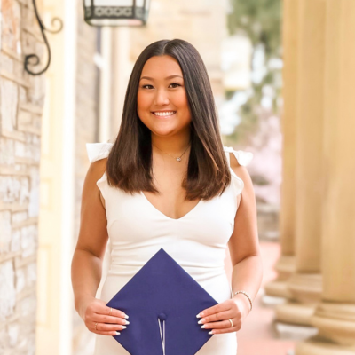 Gabby holding her grad cap
