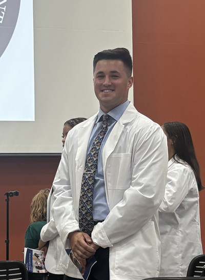 Aleks wearing his white coat