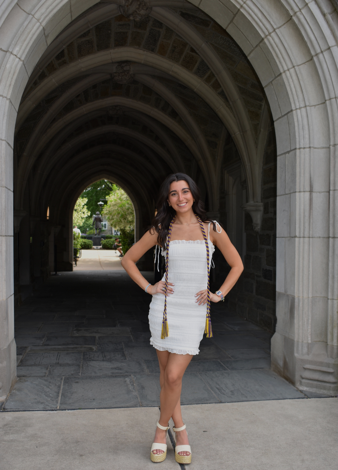 Mia wearing a white dress