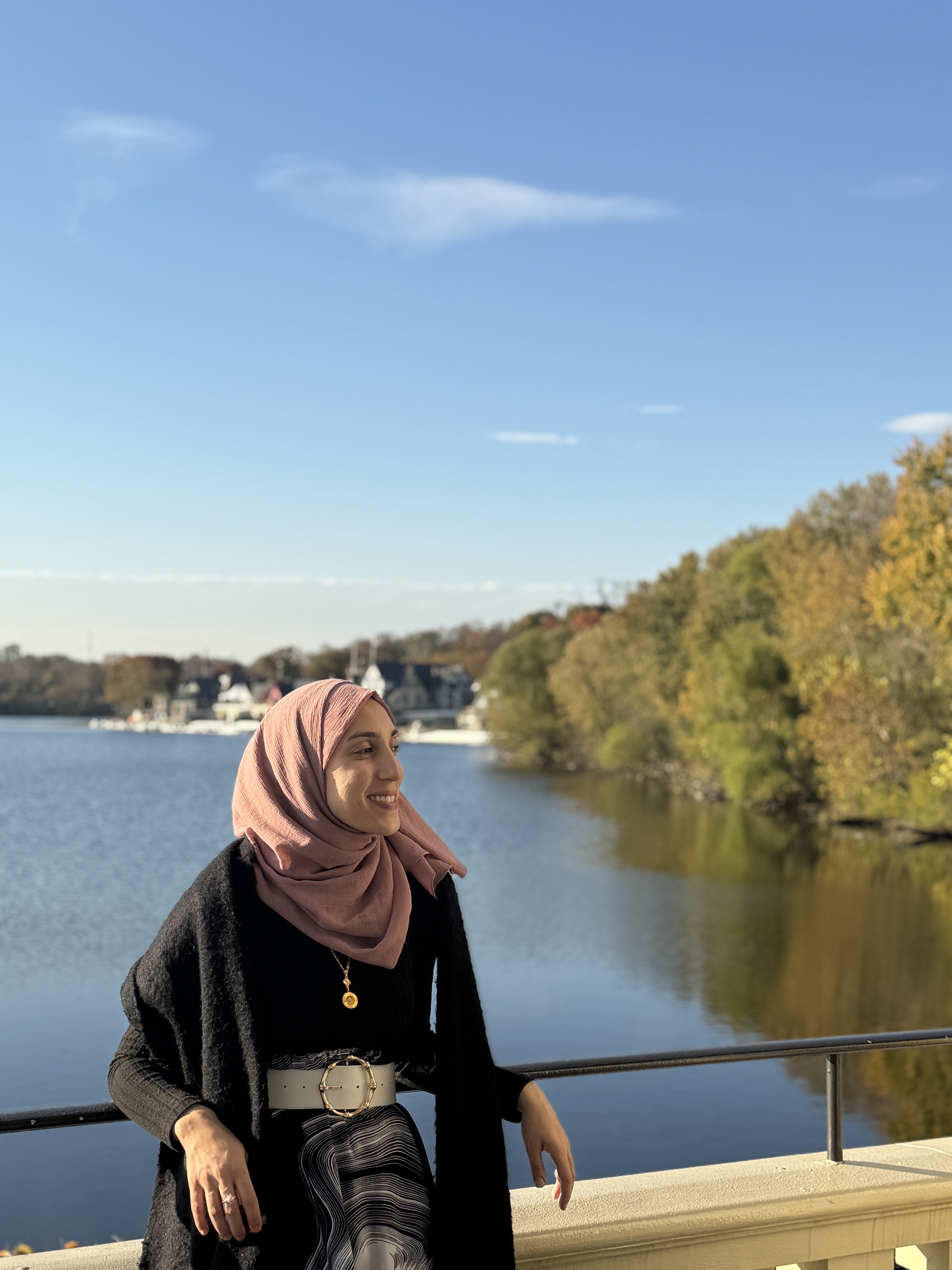 Amal leaning against a railing