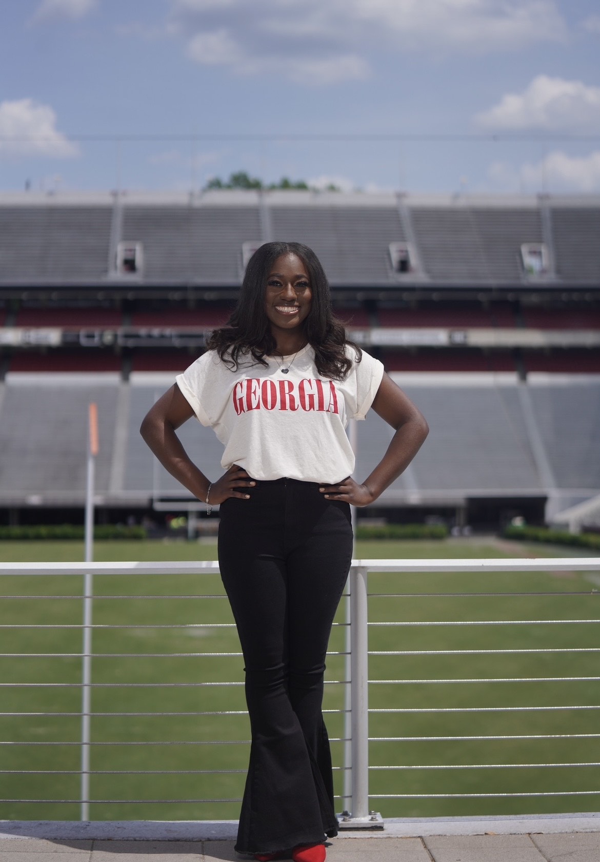 Latia standing in front of a stadium