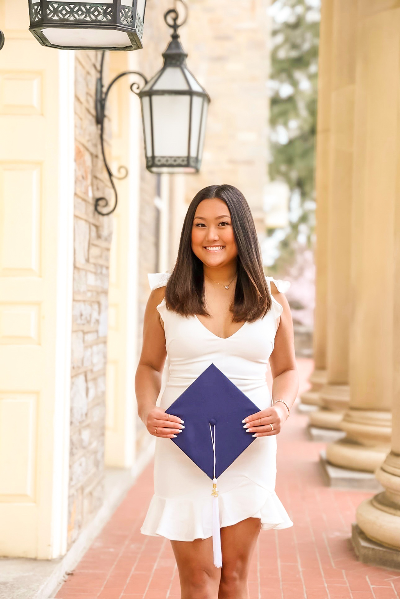 Gabby holding her grad cap