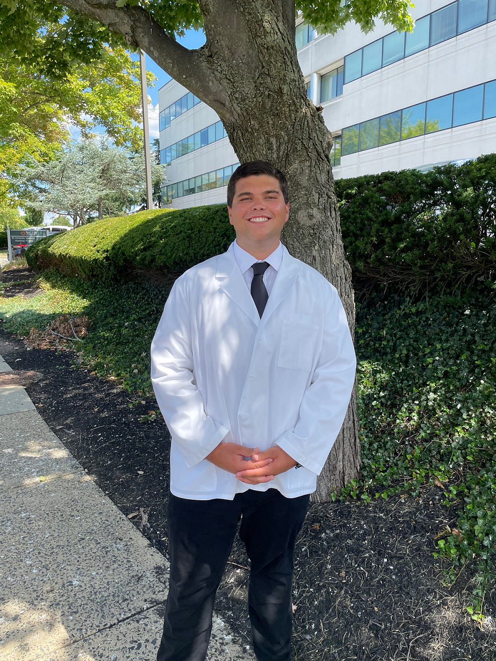 Jacob headshot wearing white coat