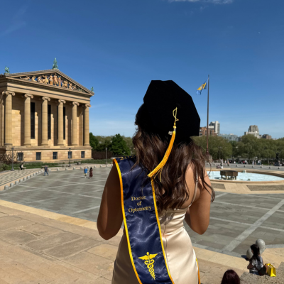 Joanna wearing her regalia, facing away from camera