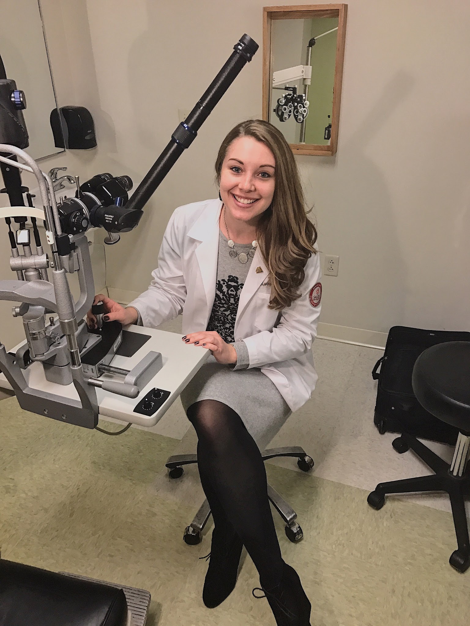 Kelsey sitting in an optometry exam room