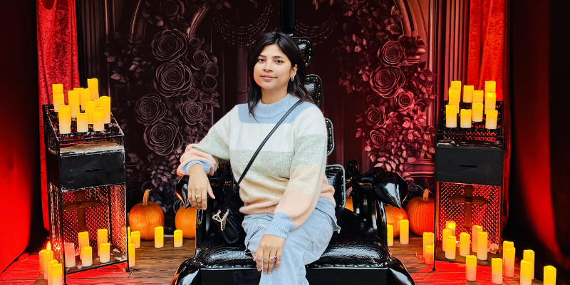 Kiran sitting on throne surrounded by candles