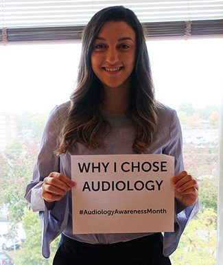 Marissa holding a sign that says "why i chose audiology"