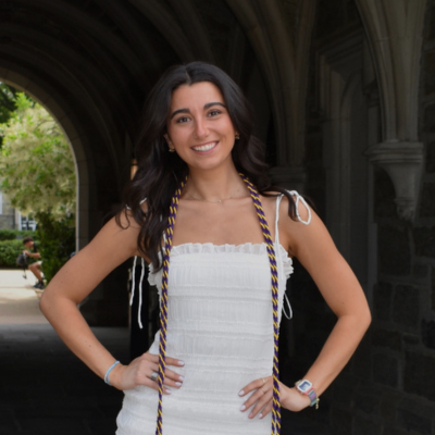 Mia wearing a white dress