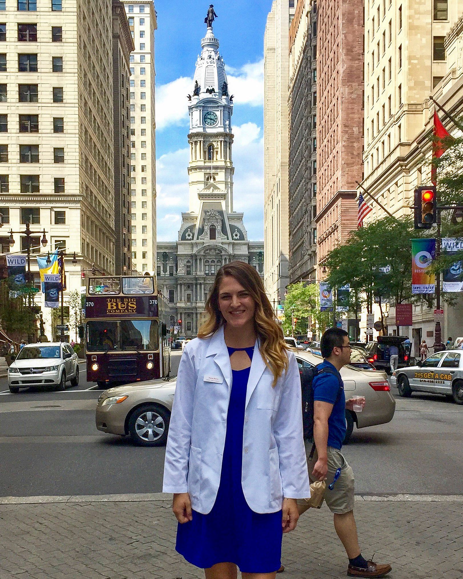 Payton standing outside of City Hall in her white coat